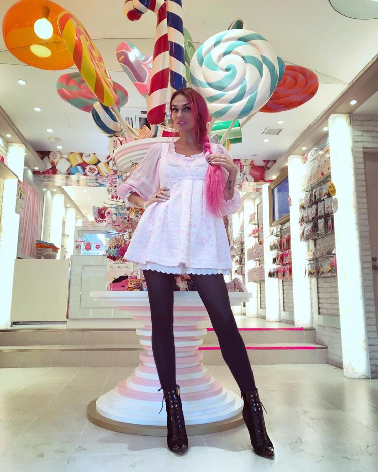 Alena Vodonaeva against the background of lollipops