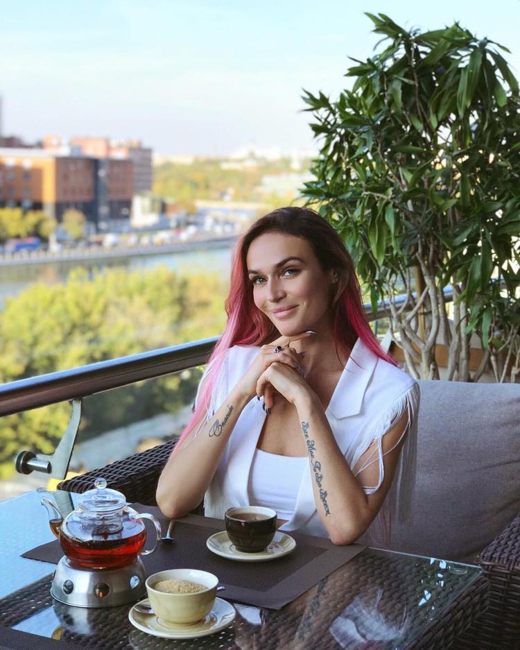 Alena Vodonaeva with a cup of coffee