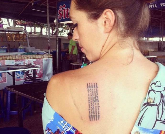 brünettes Mädchen mit einer Tätowierung auf dem Schulterblatt