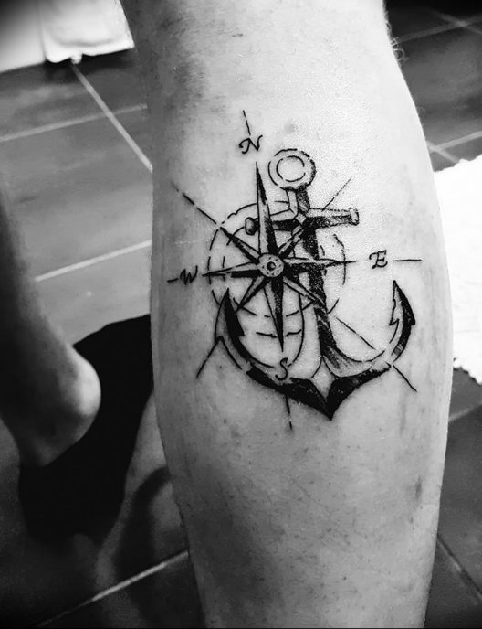 Black and white anchor foot tattoo