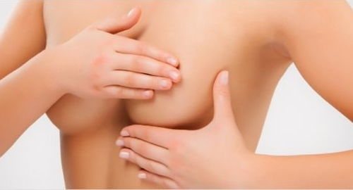 The girl covers her nipples with the palm of her hand