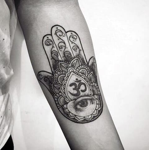 Hamsa eye tattoo on the arm of a girl