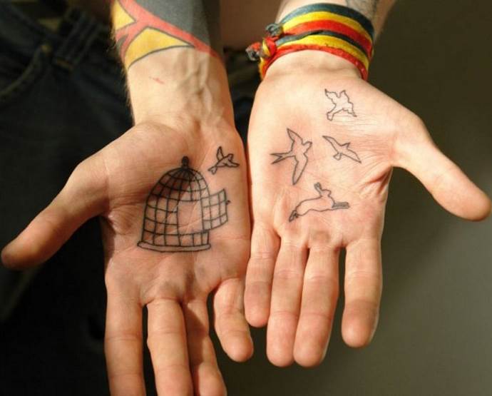 Cage and birds on the palm