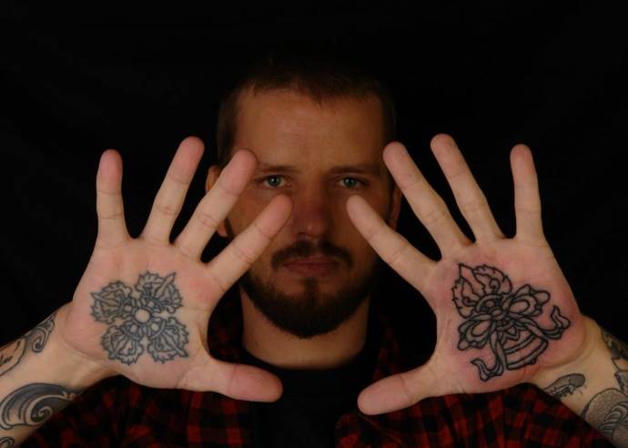 a man with tattoos on his arms