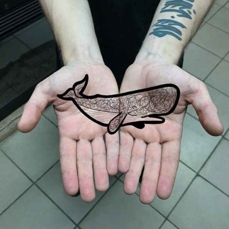 Tattoo of a whale on the palm