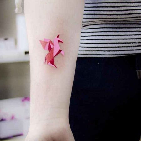 Origami tattoo unicorn on the forearm