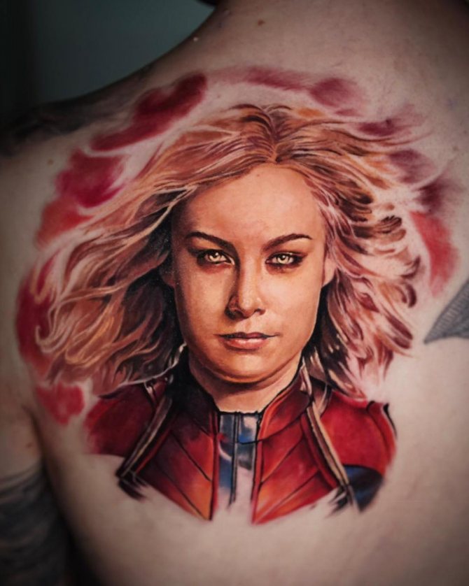 Captain Marvel character tattoo on his back