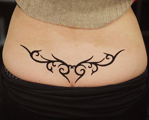 Tatouage sur le coccyx pour les filles. Photo et signification
