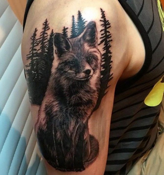 Tattoo on the arm with a fox and a forest