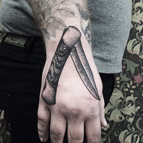 Tattoo bowie knife. Photo, signification, croquis avec rose, inscription, toile d'araignée