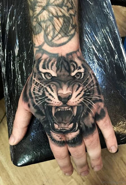Tatouage d'un tigre souriant sur une main