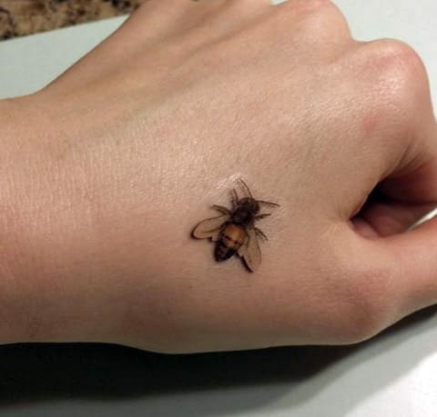 Tattoo bee on wrist