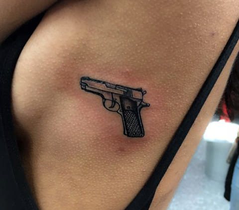 Tattoo a gun on a girl's side
