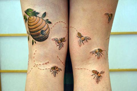 Tattoo with bees and a beehive