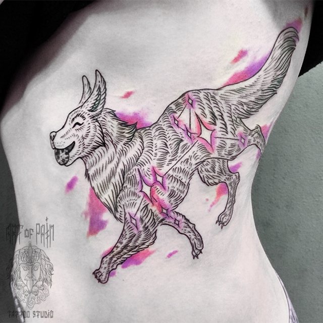 Tattoo of a dog on a girl's ribs