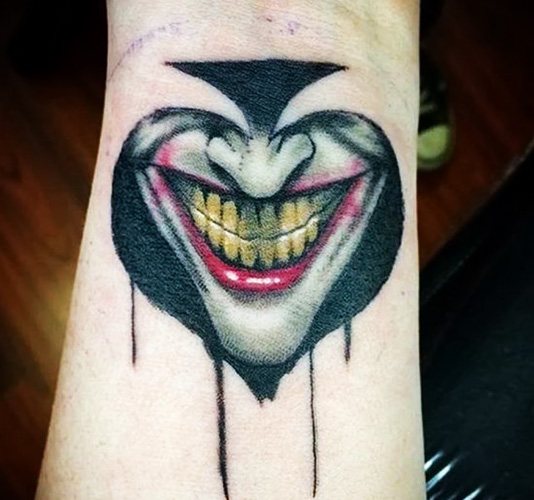 Tattoo Joker's Smile on his arm. Sketches, photo