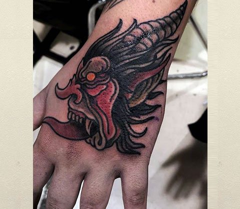 Chinese demon tattoo on hand