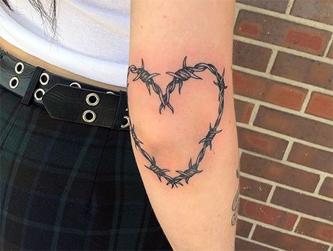 Tatuaje de corazón de alambre de púas en una chica